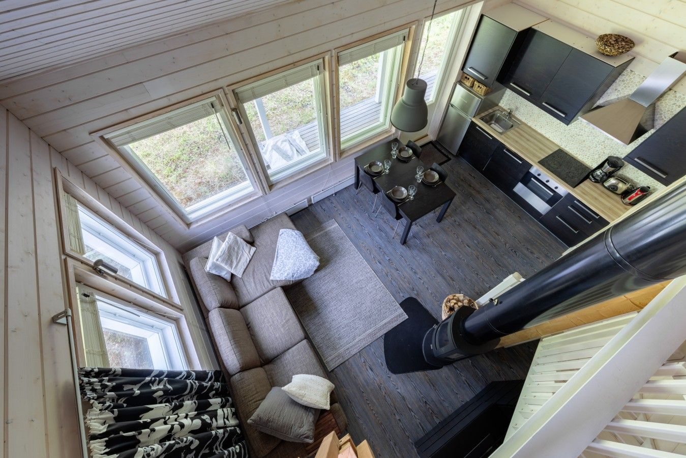 A modern interior with a sofa, dining table, and kitchen area.