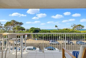 A balcony with a view of a parking lot and trees. - 11 Muroy Court - 50 Alexandra Parade Maroochydore (Maroochydore)