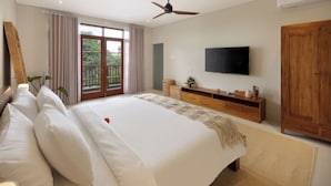A bedroom with a large bed, a wooden dresser, a flat-screen TV, and a ceiling fan. - Villa Reviva by Villa Finder (Seminyak)