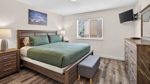 A bedroom with a bed, bedside tables, a nightstand, a dresser, a television, and a window with blinds. - 4-F Las Sal Mountain Condo (2nd Floor/Pool View) (Moab)