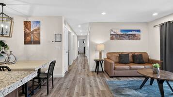A modern interior with a dining area, a sofa, and a coffee table.