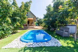A backyard with a swimming pool, a wooden deck, and a house. - Villa Escape -  a villa that sleeps 6 guests  in 2 bedrooms (Polis)