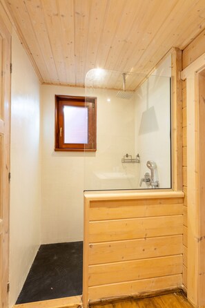 A wooden-paneled bathroom with a shower, a window, and a mirror. - Villa Escape -  a villa that sleeps 6 guests  in 2 bedrooms (Polis)