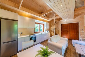 A modern kitchen with white cabinets, a stainless steel refrigerator, and a window above the sink. - Villa Escape -  a villa that sleeps 6 guests  in 2 bedrooms (Polis)