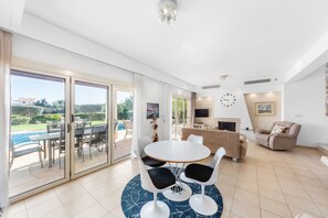 A spacious living area with a dining table, chairs, a sofa, and a fireplace. - Villa Latchi Marina 3 -  a villa that sleeps 6 guests  in 3 bedrooms (Latchi)