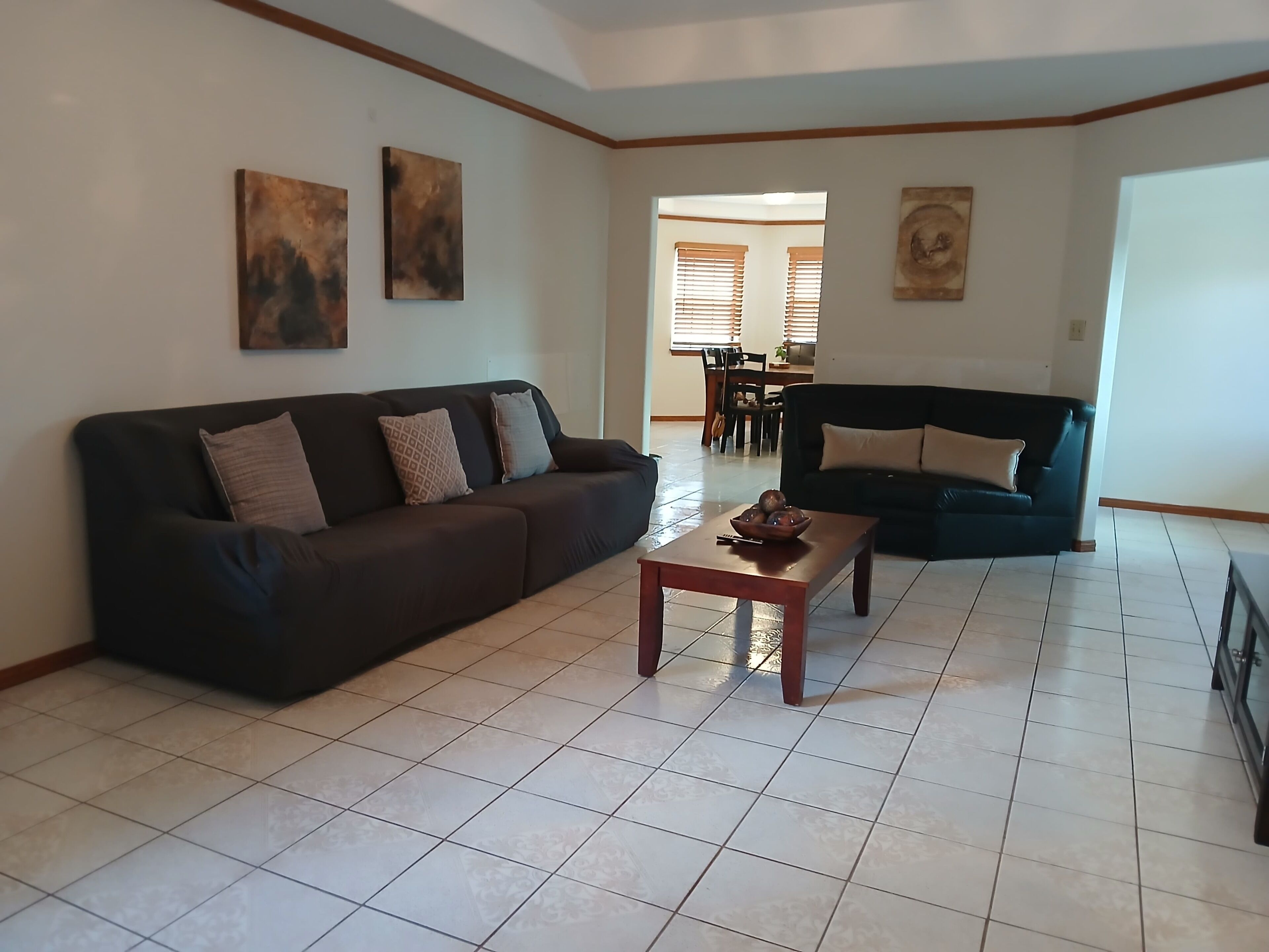 A living room with two sofas, a coffee table, and artwork on the walls.