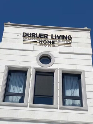 A building with a sign reading 'DURUER LIVING HOME'.