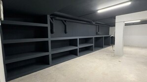 A clean, empty room with grey shelving units and a concrete floor. - Villa Las Golondrinas New 100% July 2026  20 minutes walk from Sitges Beaches (Sitges)