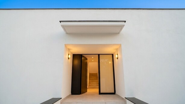 A modern entrance with a recessed light, a dark door, and a staircase leading inside. - Villa Las Golondrinas New 100% July 2026  20 minutes walk from Sitges Beaches (Sitges)
