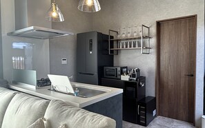 A compact kitchen with a built-in microwave, a coffee machine, and a wine rack. - Solana Private Villa Minami-Alps (Minami-Alps)