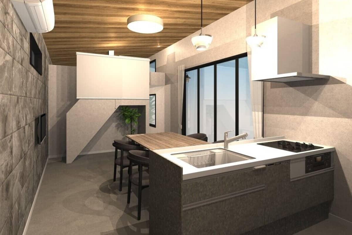 Una cocina moderna con una isla central, electrodomésticos integrados y un comedor con sillas.