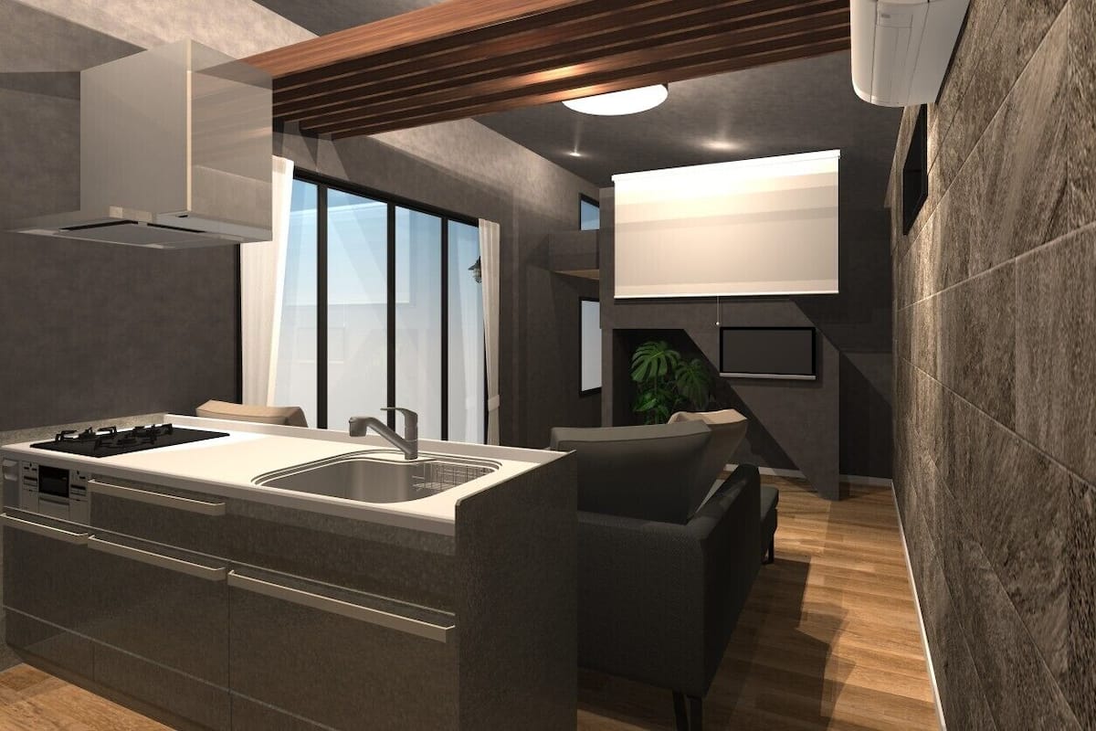 Una cocina moderna con una isla central, horno empotrado y un amplio ventanal.