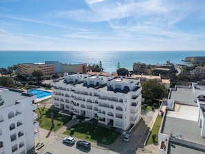 A multi-story hotel with a rooftop pool, a parking area, and a view of the sea. - Ocean Mood by Interhome (Porches)