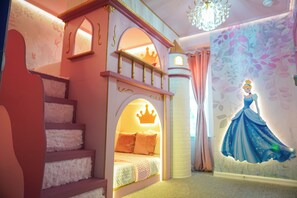 A children's bedroom with a castle bed, a mural of a princess, and a chandelier. - 5BR Themed Villa · Pool · Windsor Cay · Disney (Clermont)