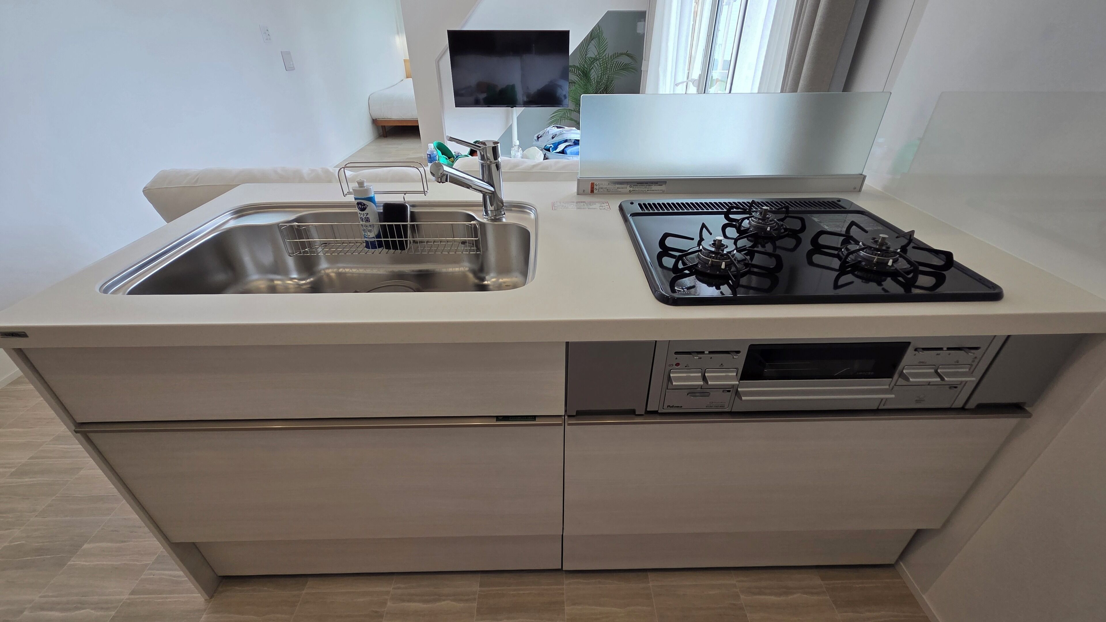 A compact kitchen with a sink, stove, and dishwasher.