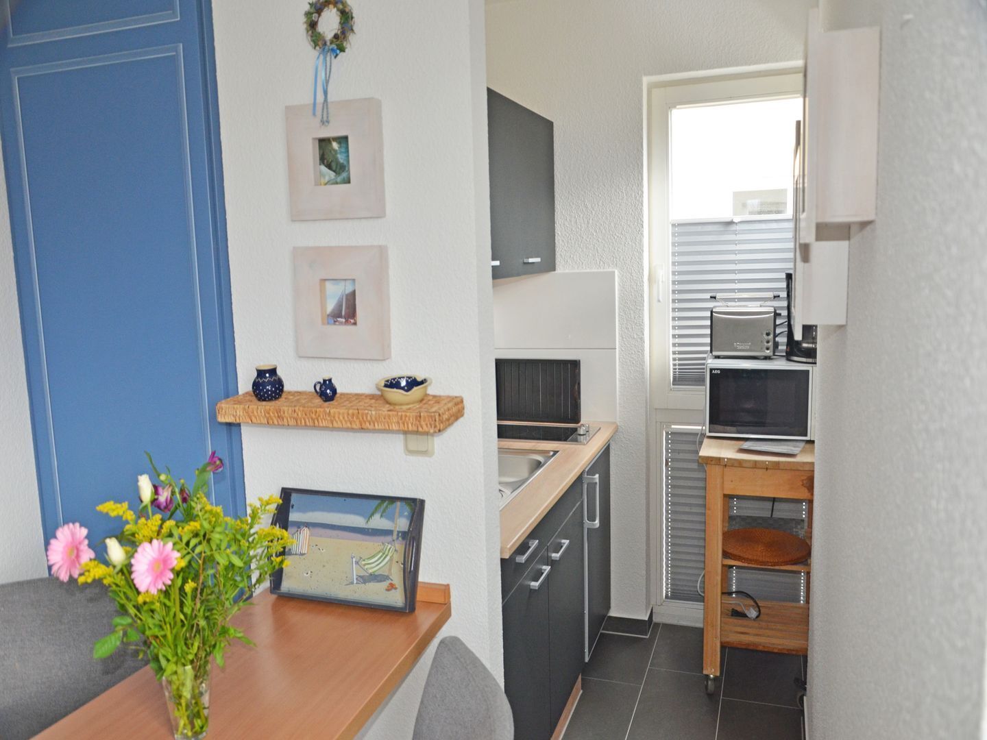 A compact kitchenette with a microwave, toaster, and coffee maker.