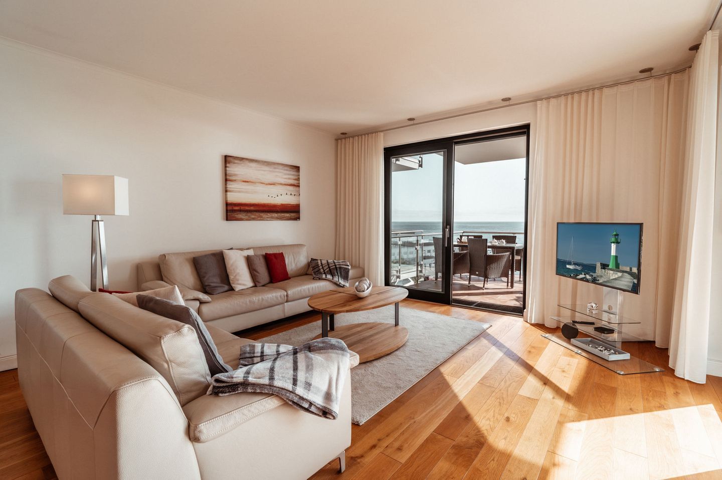 A modern living room with a sofa, coffee table, and a television.