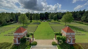 A cemetery with rows of graves, two small brick structures, and a central monument. - Pet-Friendly Forest Lodge with Fenced Garden (Rijssen)