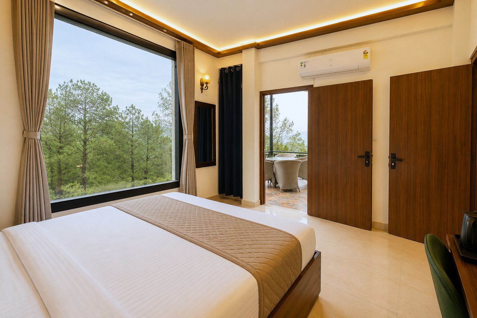 A hotel room with a large bed, a view of the outdoors, a balcony, and a door leading to another room.
