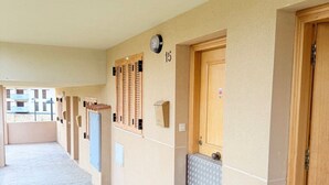 A corridor with doors numbered 15, 16, and 17, a tiled floor, and a small window.