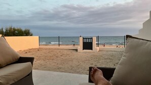 A beach view with a fence, a gate, and a person sitting on a chair. - Magnificent sea view from this apartment (Agde)