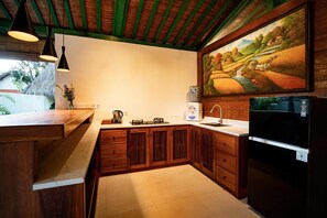 Una cocina con armarios de madera, un lavamanos, una estufa y un refrigerador.