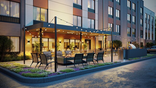 A modern hotel exterior with outdoor seating, a covered patio, and a car parked nearby. - Hyatt Studios Superior/Boulder (Superior)