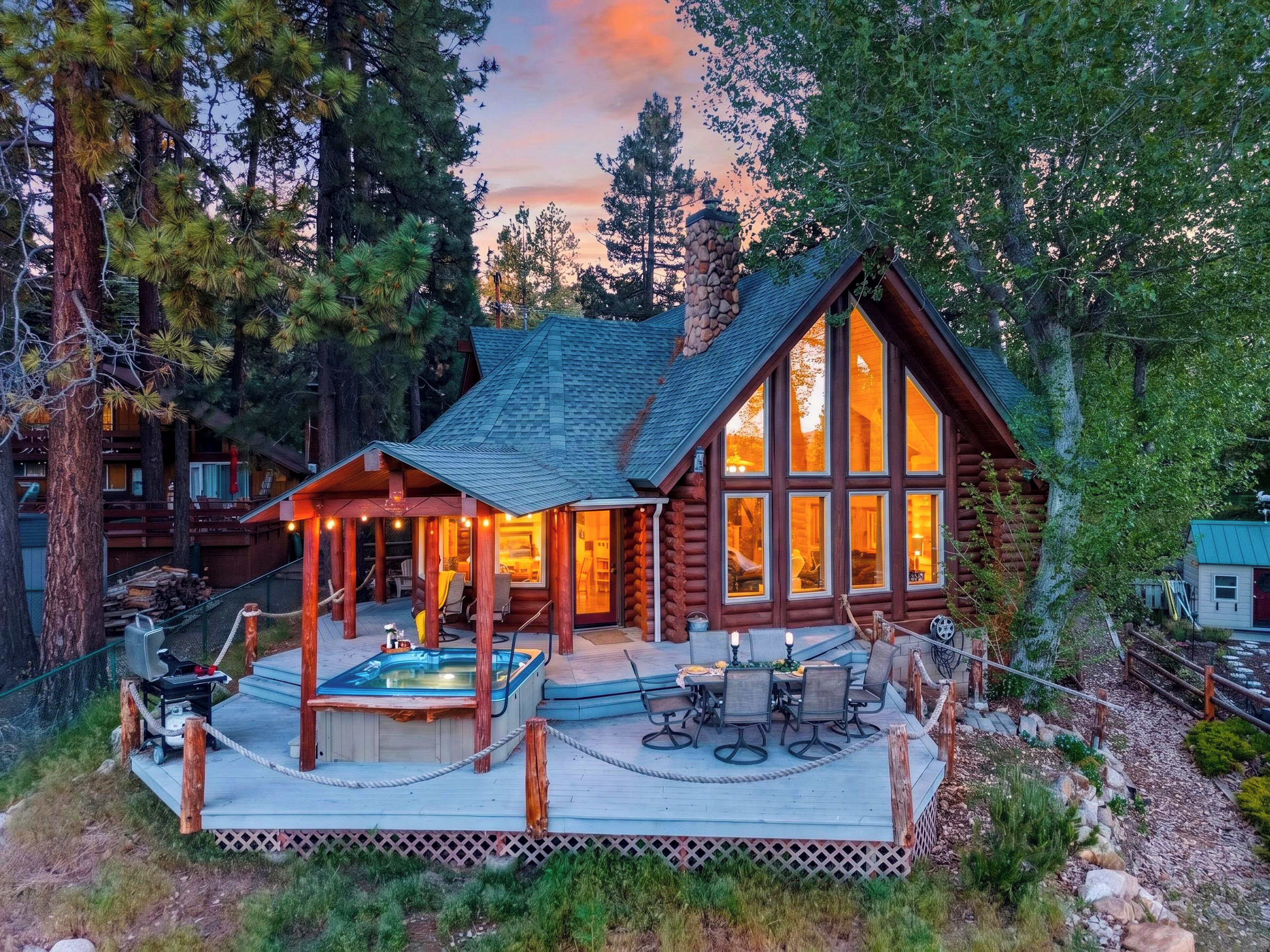 Twinkling lights, a private hot tub, and soaring windows make this mountain cabin the perfect place to unwind after a day of adventure.