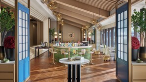 A bar area with a round table, multiple chairs, and a variety of bottles. - voco Lhasa Chengguan by IHG (Lhasa)