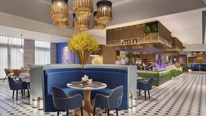 A modern hotel lobby with a seating area, a bar, and a decorative plant arrangement. - voco Lhasa Chengguan by IHG (Lhasa)