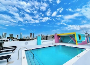 A rooftop pool with a city skyline in the background. - Rooftop Pool · Heart of Wynwood · Modern Loft (Miami)