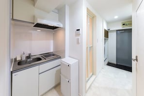 A compact kitchen with a sink, a small refrigerator, and a stove hood. - Opening in 2026 1 minute walk from Tojinmachi St / Fukuoka City Fukuoka (Fukuoka City)