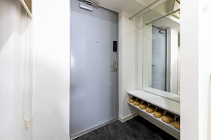 A door with a handle, a mirror above it, and a shoe rack with shoes. - Opening in 2026 1 minute walk from Tojinmachi St / Fukuoka City Fukuoka (Fukuoka City)