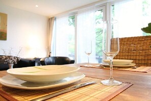 A dining table set with plates, a glass, and a knife. - 1 - Langerwisch Manor (Michendorf OT Langerwisch)