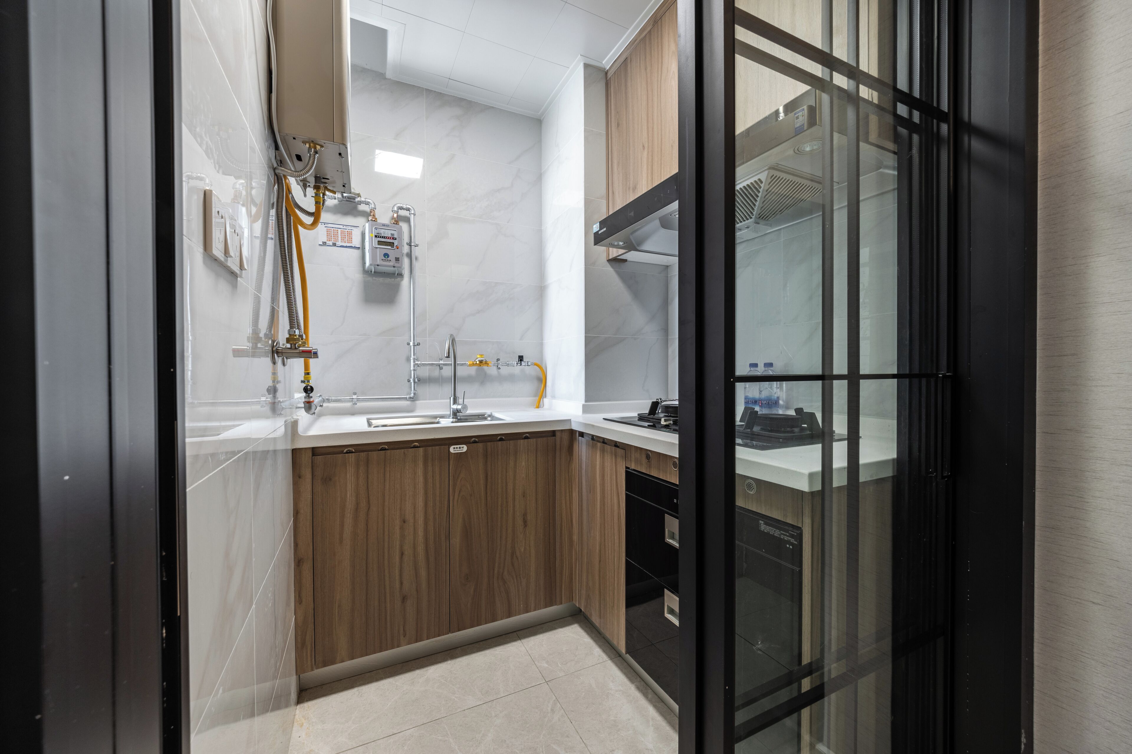 A modern kitchen with a wooden countertop, a sink, and a built-in oven.