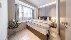A modern hotel room with a large bed, bedside table, lamp, and a window with curtains. - Bailai audio & video yaju (Shenzhen)