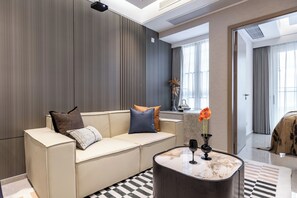 A modern living room with a beige sofa, a marble coffee table, and a checkered floor. - Bailai audio & video yaju (Shenzhen)