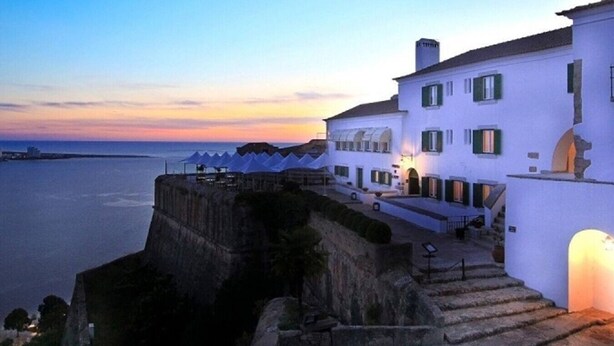 A coastal building with a stone staircase leading to a balcony, overlooking the sea. - Modern Coastal Ocean Breeze Studio | Beach & Town (Setúbal)
