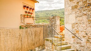 A narrow stone staircase leading to a balcony with potted plants. - LITTLE PALACE SWIMING POOL Unique in the center (Besalu)