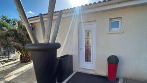 Ein Gebäude mit einer Tür, einem kleinen Fenster und einem roten, zylindrischen Gegenstand.