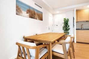 A modern kitchen with wooden cabinets and a built-in oven. - Sea View Apartment with Terrace - Sunlight (La Vila Joiosa)