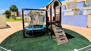 A playground with a climbing structure and a slide. - Holiday Home 'Grecia' with Mountain View, Wi-Fi and Air Conditioning (Vergel)
