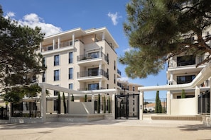 A multi-story residential building with balconies, a gated entrance, and surrounding trees. - Zenao Appart'hôtels Aix Rambot (Aix-en-Provence)