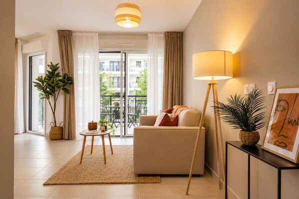 Un salon moderne avec un canapé, une lampe sur pied, une petite table et une plante en pot.
