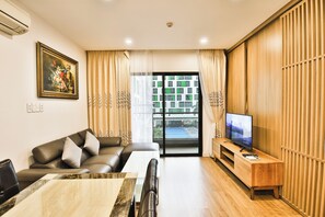 A modern living room with a sofa, TV, and dining area. - Republic Plaza TSN Airport Emily in Town (Ho Chi Minh)