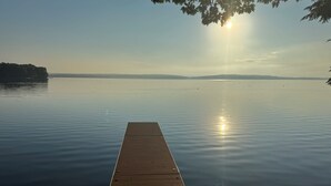 A wooden dock extending into calm water with a clear sky above. - Lakefront Retreat on Sebasticook Lake (Newport)