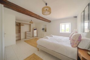 A bedroom with a large bed, a wooden ceiling beam, a hanging light fixture, a window, and a wardrobe. - Le Clos Vinzelles - House + outbuilding in the heart of the vineyards, large garden (Vinzelles)