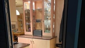 A kitchen with a built-in cabinet, a countertop, and a microwave. - 2 Bed - Sleeps 6 - Lake View - Beach Access - Pets (Skegness)