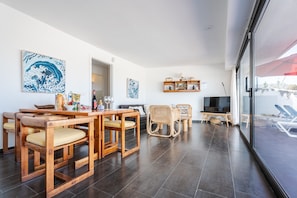 A modern living room with a dining area, wooden furniture, and artwork on the walls. - Quicksand • Ocean views • Beach 1 min • LVH (Famara)
