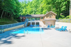 A swimming pool with lounge chairs, a no diving sign, and a building with a staircase. - Beary Cozy | Hot Tub | Both Beds w/ Private Bath | Sleeps 6 (Pigeon Forge)
